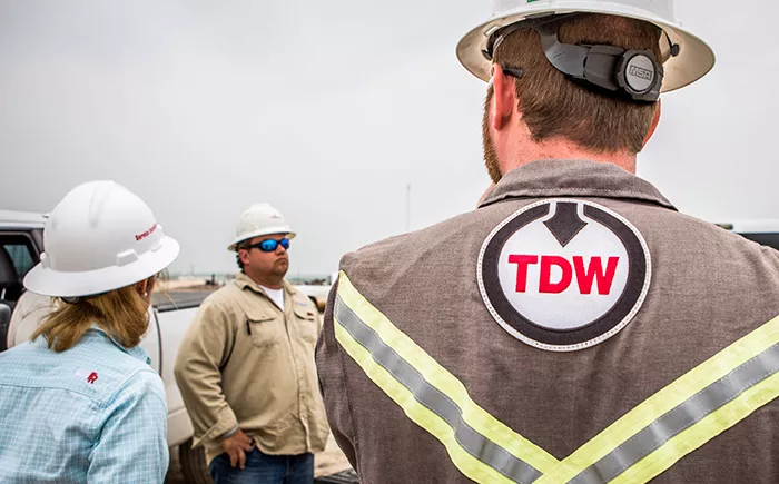 TDW technicians in the field wearing protective gear and preparing for an inline inspection job