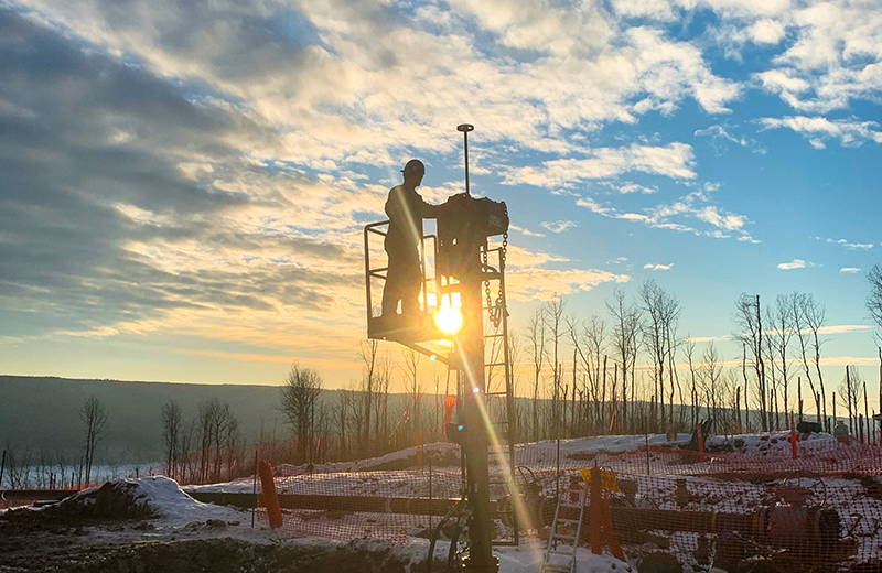 TDW Technician overlooking jobsite from hot tapping machine