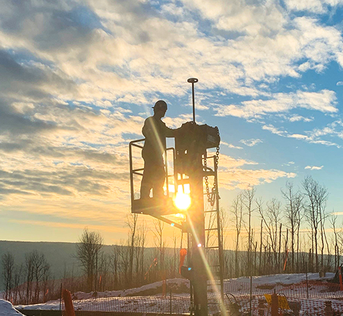 Technician on a job site at sunset