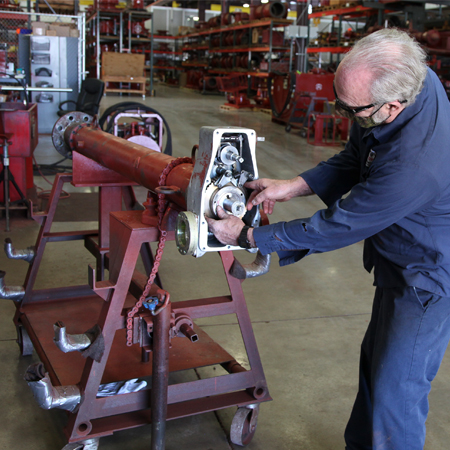 Maintenance technician working on equipment at TDW service center