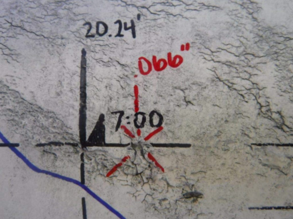 Circumferential stress corrosion cracking example with crack features indicated by marks on pipeline