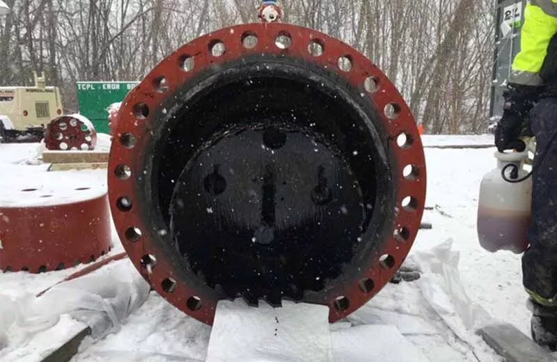 Hot tapping machine shown in the field in a snowy environment as technicians prepare to respond to a pipeline emergency